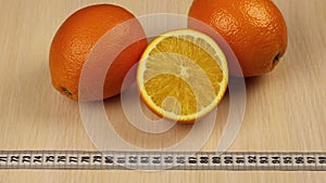 Slimming and healthy lifestyle concept. Close-up oranges and tape-line.