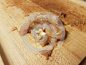 Slimy raw chicken meat on cutting board