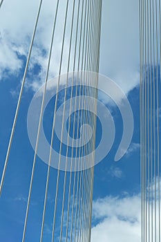 Sling line up into the air on suspebsion bridge on blue sky with