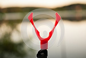 Slingshot for installing fishing rods while fishing on the lake background