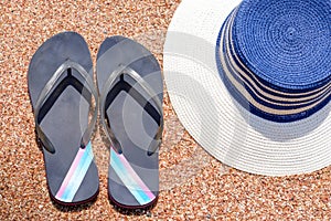 Slip slops and sunhat on a tropical beach photo