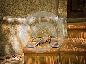 Slippers on the steps of a porch