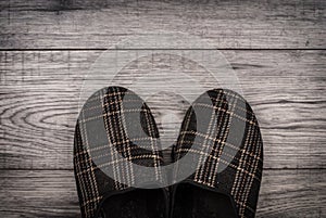 Slippers on wooden background.