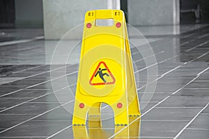 Slippery floor surface warning sign and symbol in building, hall