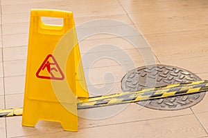 Slippery icon on yellow plastic warning sign alerts for hazard o
