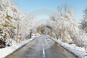 Slippery snow covered country road during winter.