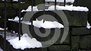 Slippy old stairs covered in snow in winter after snowfall