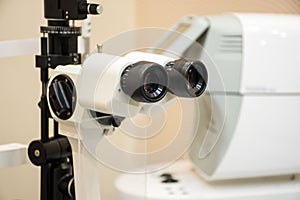 Slit lamp in diagnostic office of doctor ophthalmologist. Ophthalmic diagnostic microscopic medical equipment to diagnose cataract photo