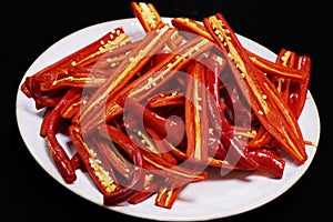 Slitted hot red chilies in plate for food preparation photo