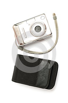 A sliver metallic digital compact point-and-shoot camera with matching black case white backdrop