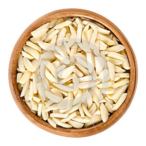 Slivered blanched almonds in wooden bowl over white