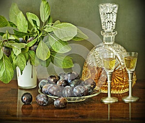 Slivovitz bottle and plums