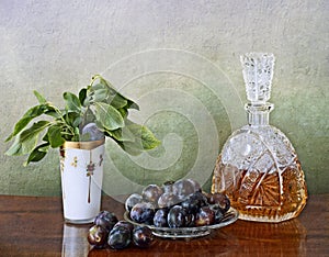 Slivovitz crystal bottle and plums