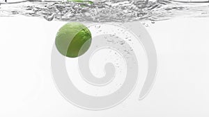 Slo-motion lime falling into water