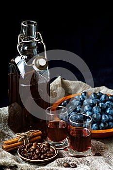 Sloe gin. Glass of blackthorn homemade light sweet reddish-brown liquid. Sloe-flavored liqueur or wine