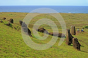 The slope full of abandoned giant Moai statues of Rano Raraku volcano with Pacific ocean in backdrop, Archaeological site in Chile