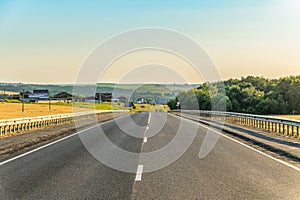 Slope rural asphalt road with marking and guard rails