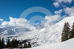 Slope in ski resort Serfaus Fiss Ladis in Austria with snowy mou