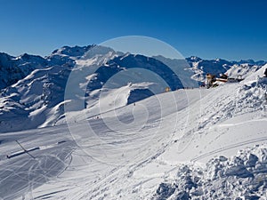 Slope on the skiing resort in Meribel. France, 2018. Blue sky without clouds and white snow.