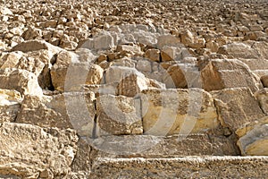 Slope of three big pyramid of Giza pyramid complex and sky behind. background of pyramid bricks. Stone wall of Egyptian pyramids