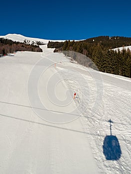 Slope view with funicular and shadow in winter in resort Ladis, Fiss, Serfaus in ski resort in Tyrol