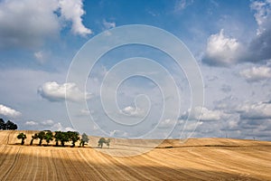 Sloping field with impressive sky and clouds