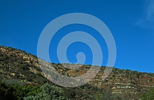 SLOPING RIDGES AGAINST BLUE SKY