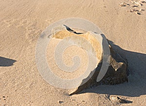 Sloping sand with rock formation at Australian beach