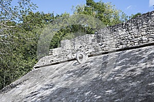 The sloping side of a Ball Court with stone ring at top for goal