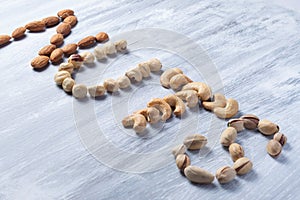 The sloping word nuts is made up of almonds, hazelnuts, cashews and pistachios