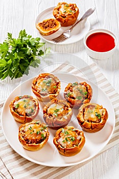 Sloppy joe cups on white plate, top view