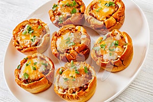 Sloppy joe cups on white plate, top view