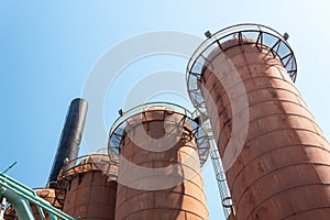 Sloss Furnaces National Historic Landmark, Birmingham Alabama USA, row of steel mill furnaces against a blue sky, copy space