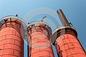 Sloss Furnaces National Historic Landmark, Birmingham Alabama USA, trio of furnaces seen from below, blue sky