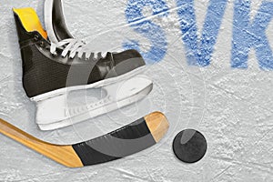 Slovak hockey stick, skates and the puck on the ice