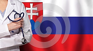 Slovak medicine and healthcare concept. Doctor close up against flag of Slovakia background