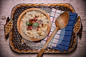 Slovak traditional dishes potato gnocchi with sheep`s cheese, on a wooden table laid on the table