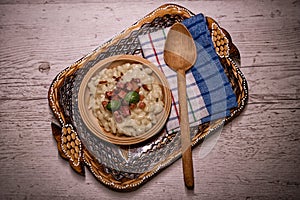 Slovak traditional dishes potato gnocchi with sheep`s cheese, on a wooden table laid on the table