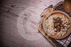 Slovak traditional dishes potato gnocchi with sheep`s cheese, on a wooden table laid on the table