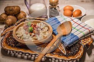 Slovak traditional dishes potato gnocchi with sheep`s cheese, on a wooden table laid on the table