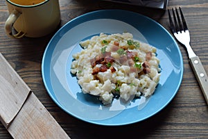 Slovak traditional potato gnocchi with sheep cheese and bacon,wooden table