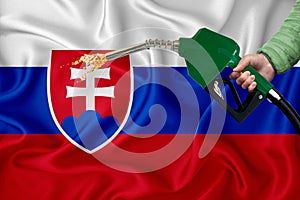 SLOVAKIA flag Close-up shot on waving background texture with Fuel pump nozzle in hand. The concept of design solutions. 3d