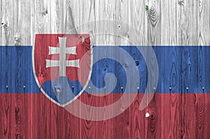 Slovakia flag depicted in bright paint colors on old wooden wall. Textured banner on rough background