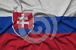 Slovakia flag is depicted on a sports cloth fabric with many folds. Sport team banner