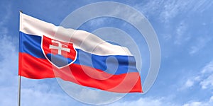 Slovakia flag on flagpole on blue sky background. The Slovak flag flutters in wind against a sky with white clouds. Place for text