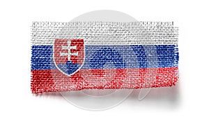 Slovenská vlajka na kuse látky na bielom pozadí
