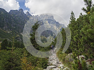 Slovakia, High Tatra mountain, September 13, 2018: Young men tourist hiking at the beautiful nature trail at high tatra mountains