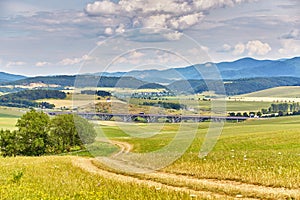 Slovakia summer landscape. Green summer fields, meadows, hills of Tatra mountains. Travel in vacations. Rural Road in Spis region