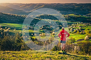 Slovakia written on red jacket of male runner who looking at beautiful morning spring landscape