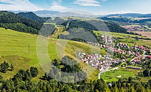 Slovakian town on grassy hillside in summer